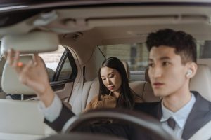 showcasing chauffeur service with driver and businesswomen